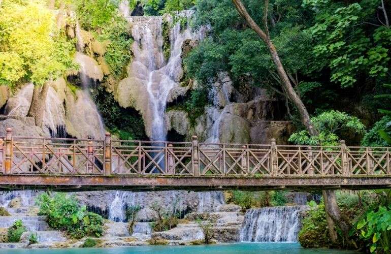 A wooden bridge over Kuang Si waterfall